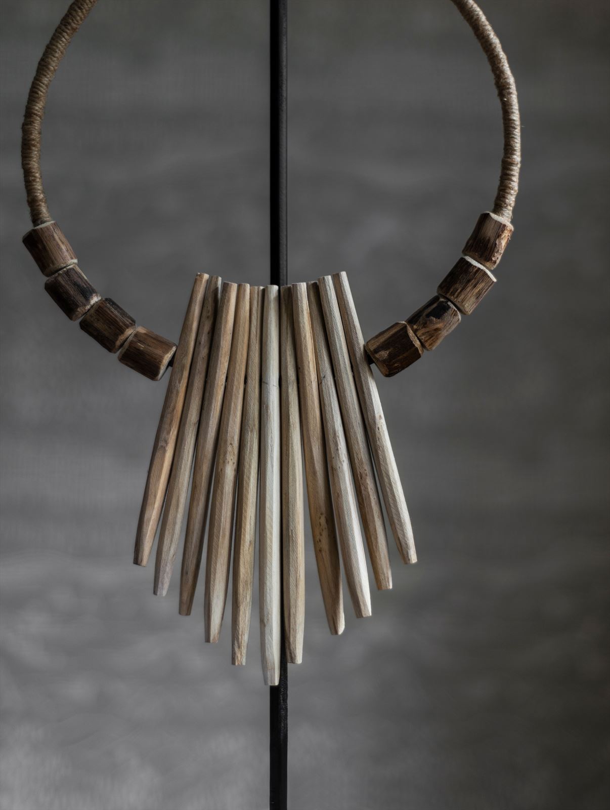 Decorative wooden necklace on an stand